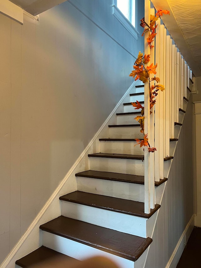 staircase with wooden walls