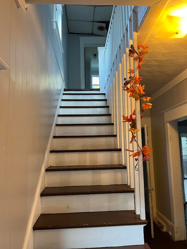 stairs with wood walls