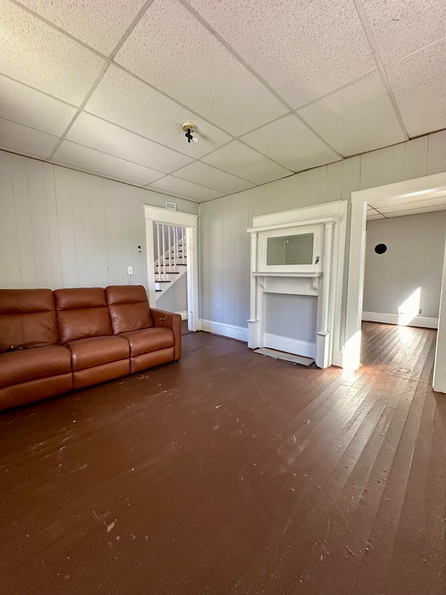 unfurnished living room featuring a paneled ceiling and hardwood / wood-style floors