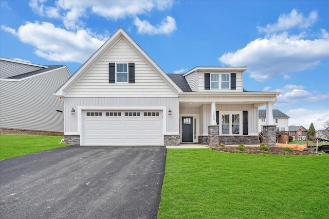 view of front of house featuring board and batten siding, driveway, and a front lawn