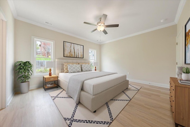 bedroom featuring light wood-type flooring, a ceiling fan, baseboards, and crown molding