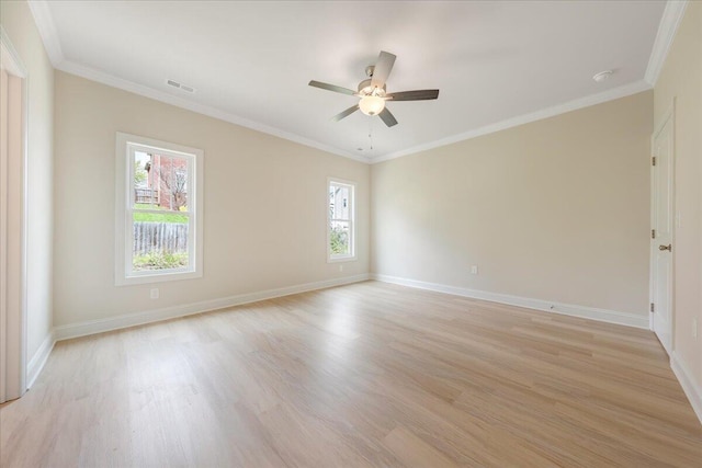 empty room with baseboards, light wood-style flooring, and crown molding