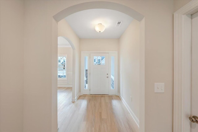 entryway featuring light wood-type flooring, visible vents, and baseboards