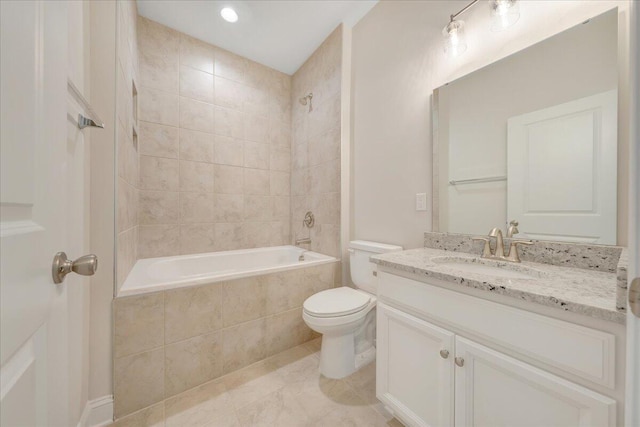 full bathroom featuring toilet, tile patterned flooring, vanity, and tiled shower / bath