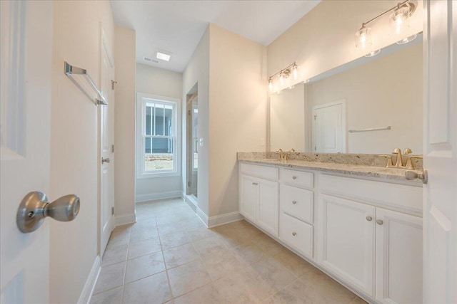 bathroom featuring vanity, an enclosed shower, and tile patterned floors