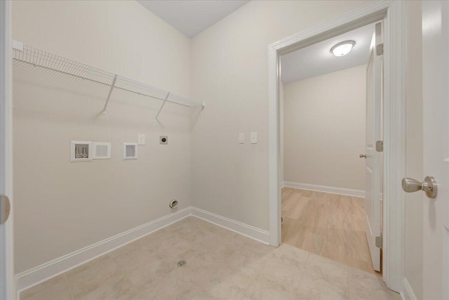 clothes washing area featuring hookup for a washing machine, light hardwood / wood-style floors, and hookup for an electric dryer