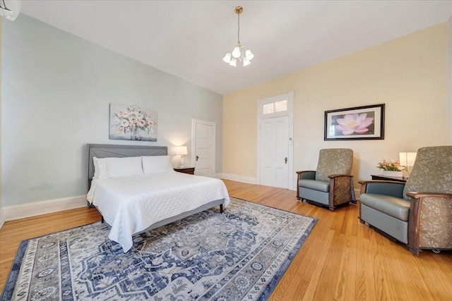 bedroom featuring a notable chandelier and light hardwood / wood-style floors