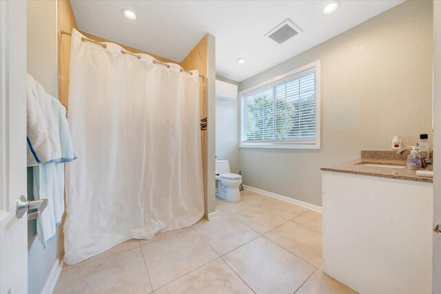 bathroom featuring tile patterned floors, a shower with curtain, vanity, and toilet