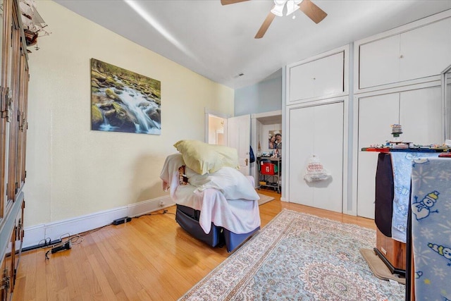 living area with ceiling fan and light hardwood / wood-style floors