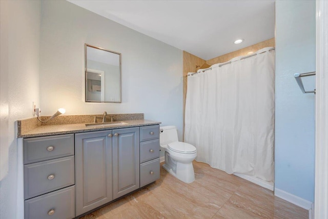 bathroom featuring vanity, toilet, and a shower with shower curtain