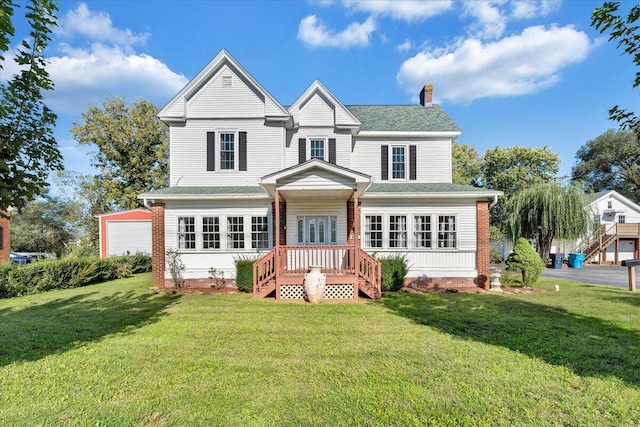 back of property with a yard and a garage