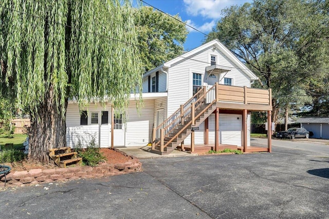 front of property featuring a wooden deck