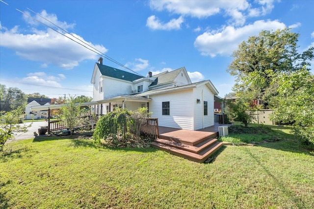 back of property featuring a lawn, cooling unit, and a deck