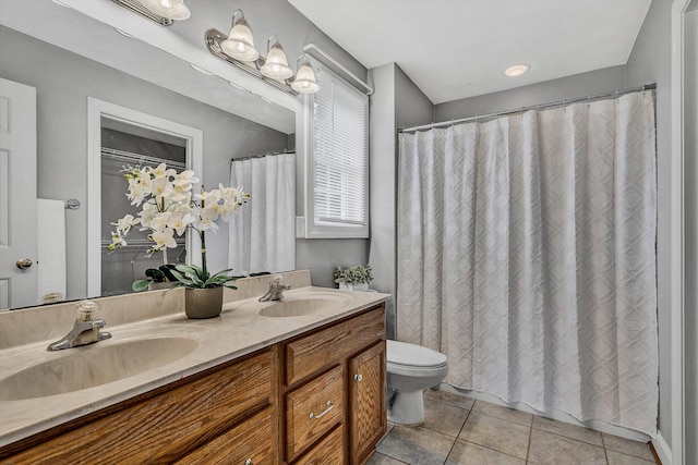 bathroom with tile patterned flooring, curtained shower, vanity, and toilet