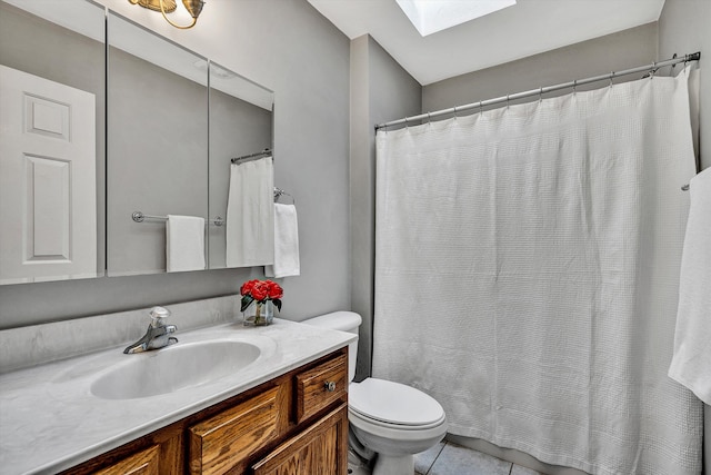 bathroom featuring a skylight, vanity, toilet, tile patterned flooring, and a shower with shower curtain