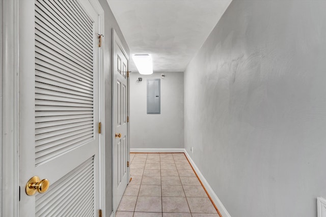 hallway featuring electric panel and light tile patterned floors