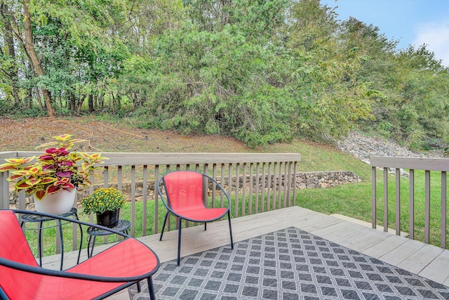 wooden deck featuring a yard