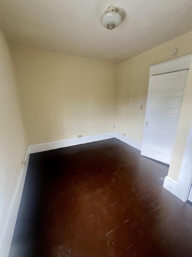 unfurnished room featuring dark hardwood / wood-style floors