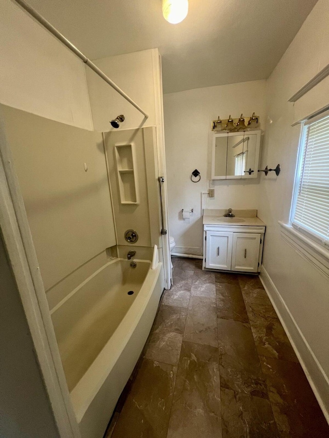 bathroom featuring washtub / shower combination and vanity