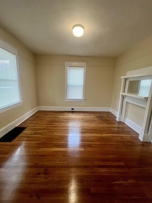 spare room with dark wood-type flooring