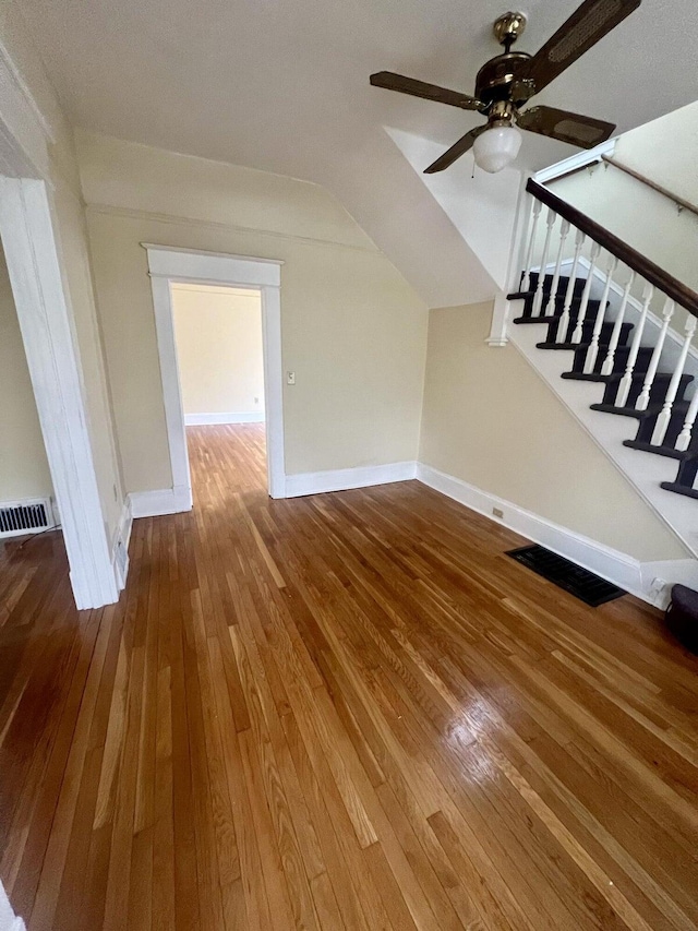 interior space with vaulted ceiling, ceiling fan, and hardwood / wood-style flooring