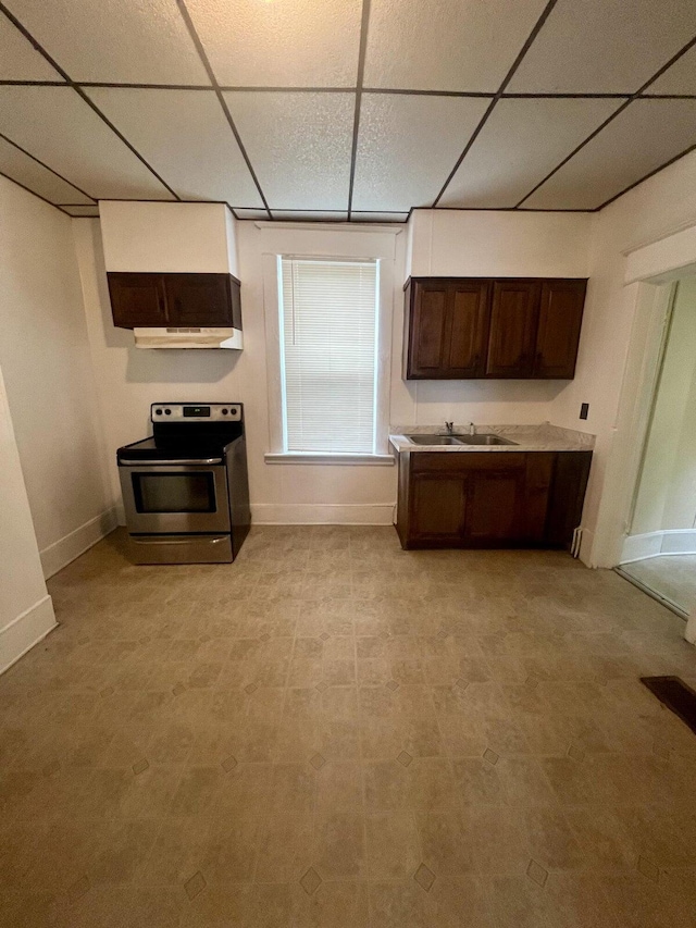 kitchen with sink, dark brown cabinets, ventilation hood, a drop ceiling, and stainless steel electric range oven