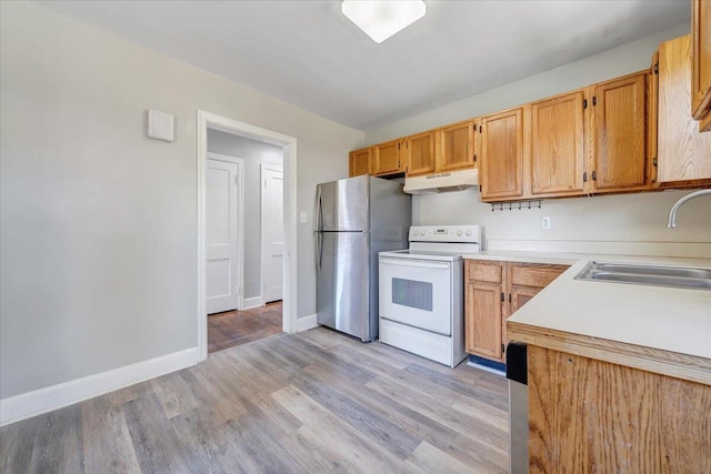 kitchen featuring light hardwood / wood-style flooring, white electric range oven, sink, and stainless steel fridge