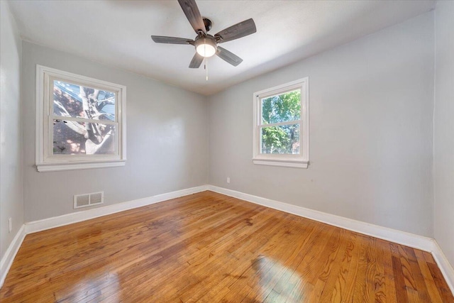 unfurnished room with hardwood / wood-style floors and ceiling fan