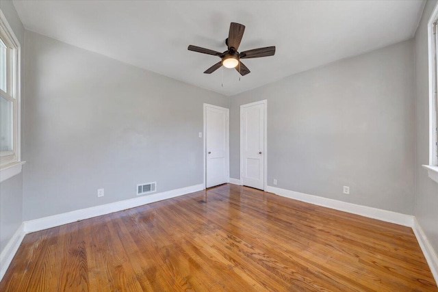 spare room featuring hardwood / wood-style floors and ceiling fan