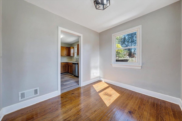 empty room featuring hardwood / wood-style flooring and sink