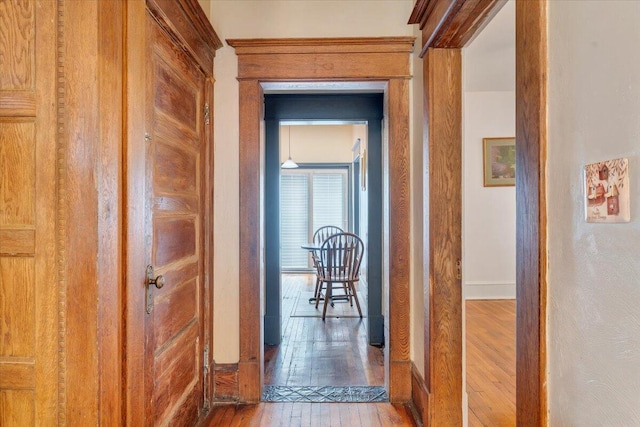 hall with hardwood / wood-style floors