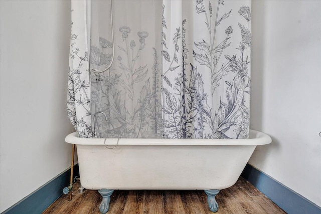 bathroom featuring hardwood / wood-style flooring and a bath