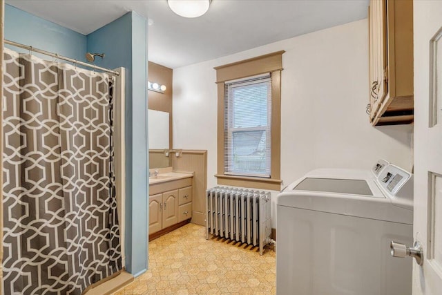 bathroom featuring vanity, washing machine and dryer, radiator heating unit, and curtained shower