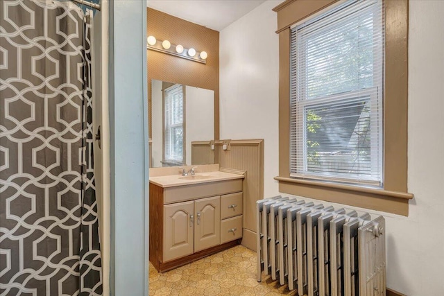 bathroom with radiator and vanity