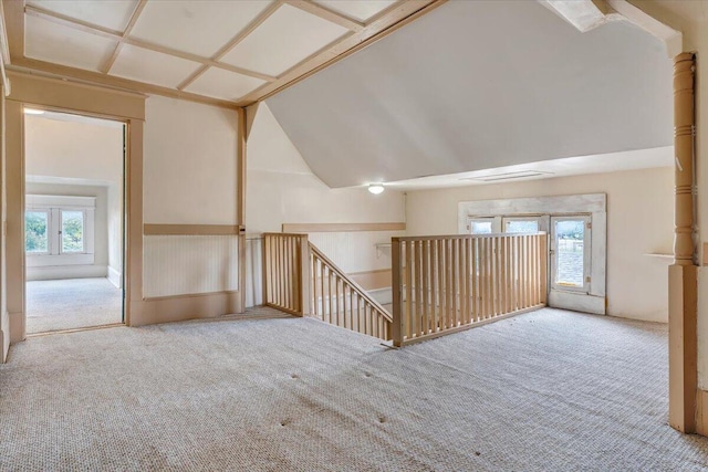 additional living space featuring carpet floors and vaulted ceiling