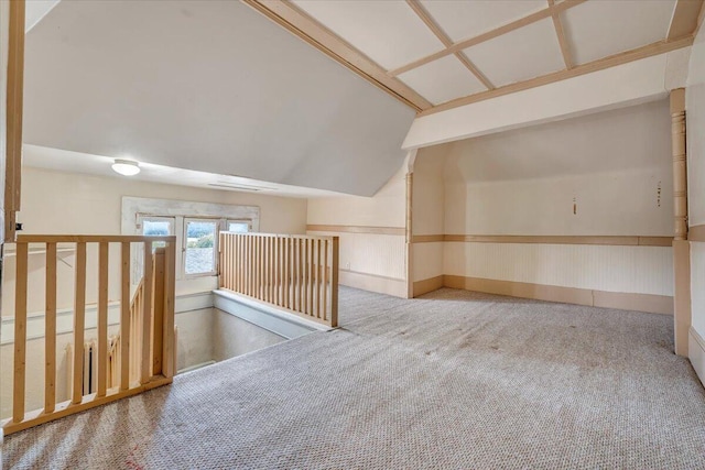 empty room with vaulted ceiling and carpet floors