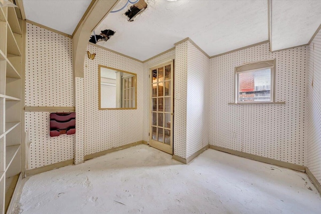 interior space featuring ornamental molding and a textured ceiling