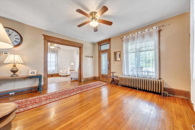 interior space with hardwood / wood-style floors, radiator, and ceiling fan