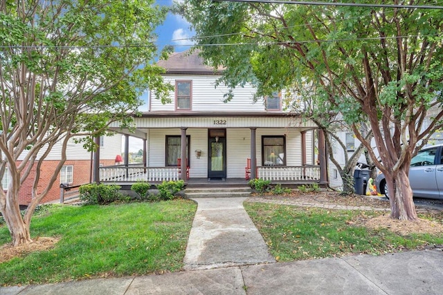 view of front of home featuring a front yard and covered porch