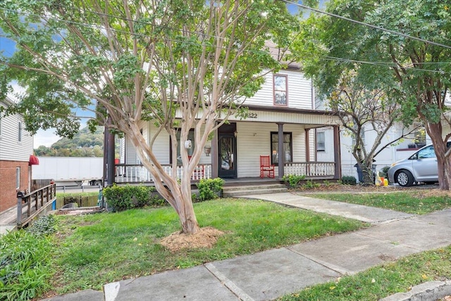 view of front facade with a front lawn and a porch