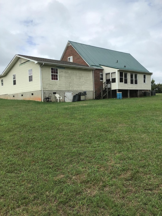 rear view of property featuring a yard