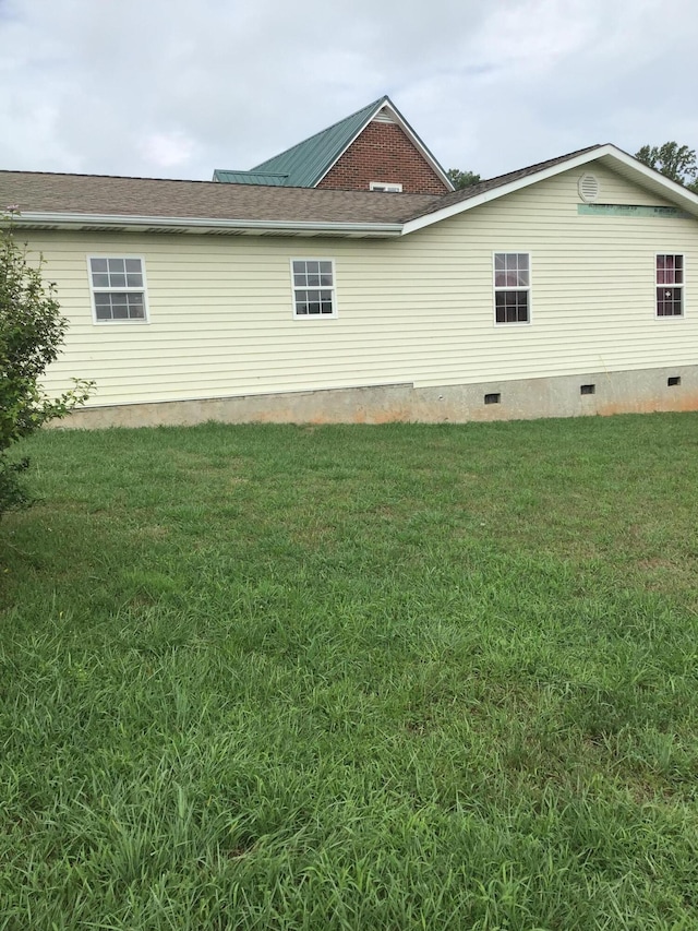 view of property exterior with a yard