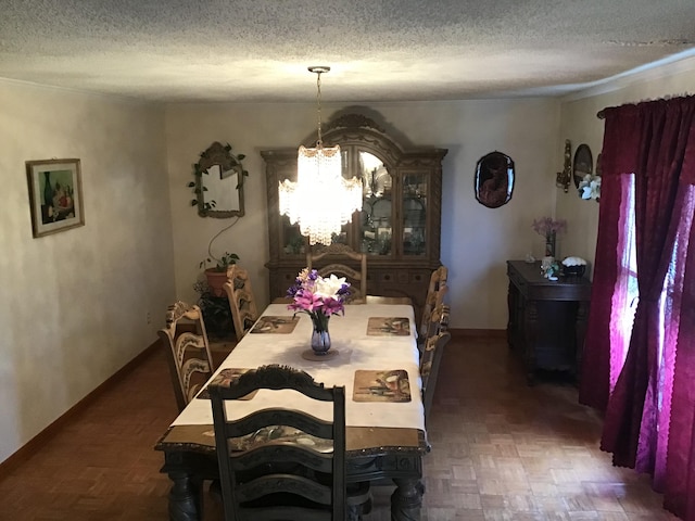 dining room featuring dark parquet flooring, a chandelier, and a textured ceiling