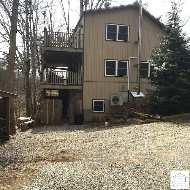 rear view of house with ac unit and a deck