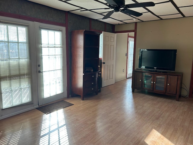 unfurnished living room with light hardwood / wood-style floors, french doors, and ceiling fan