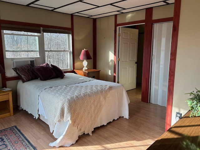 bedroom featuring cooling unit and light wood-type flooring