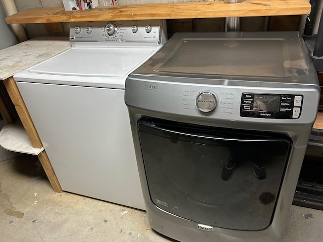 clothes washing area with separate washer and dryer