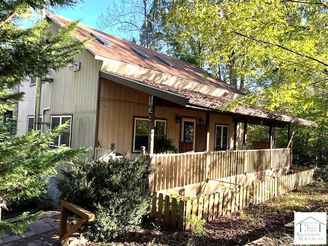 view of side of home with covered porch