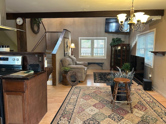 living room featuring beamed ceiling, an inviting chandelier, and light hardwood / wood-style flooring