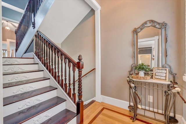 staircase with hardwood / wood-style flooring